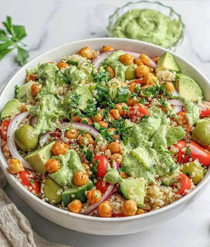 Quinoa Salad with Avocado Dill Dressing, Garlic Paprika Chickpeas, Tomatoes, Cucumbers, Olives, & Roasted Peppers
